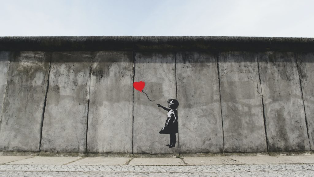 girl playing heart balloon wall artwork