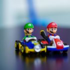 lego mini figure riding blue and red toy car